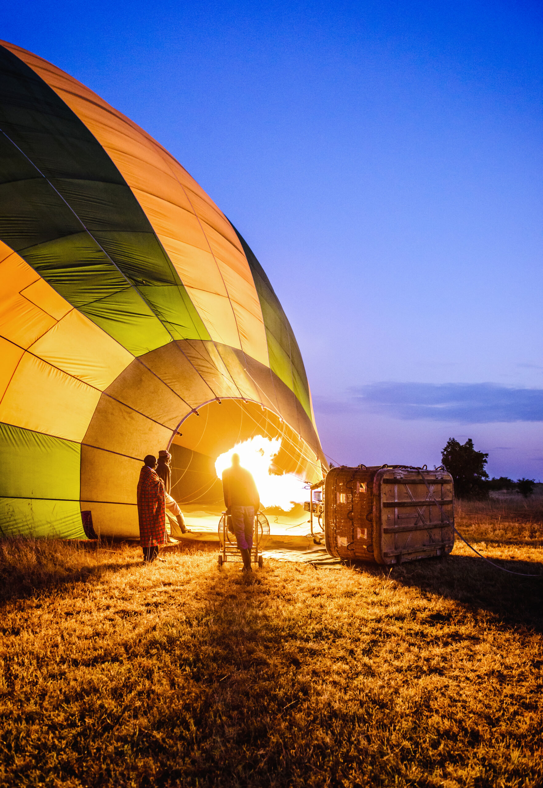 Hot air balloon inflating in rural field